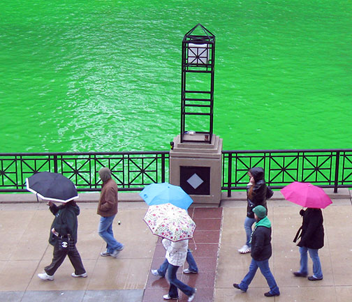 Spectators and their umbrellas on the Chicago river walk as the river is dyed green for St. Patrick's Day, March 13, 2010